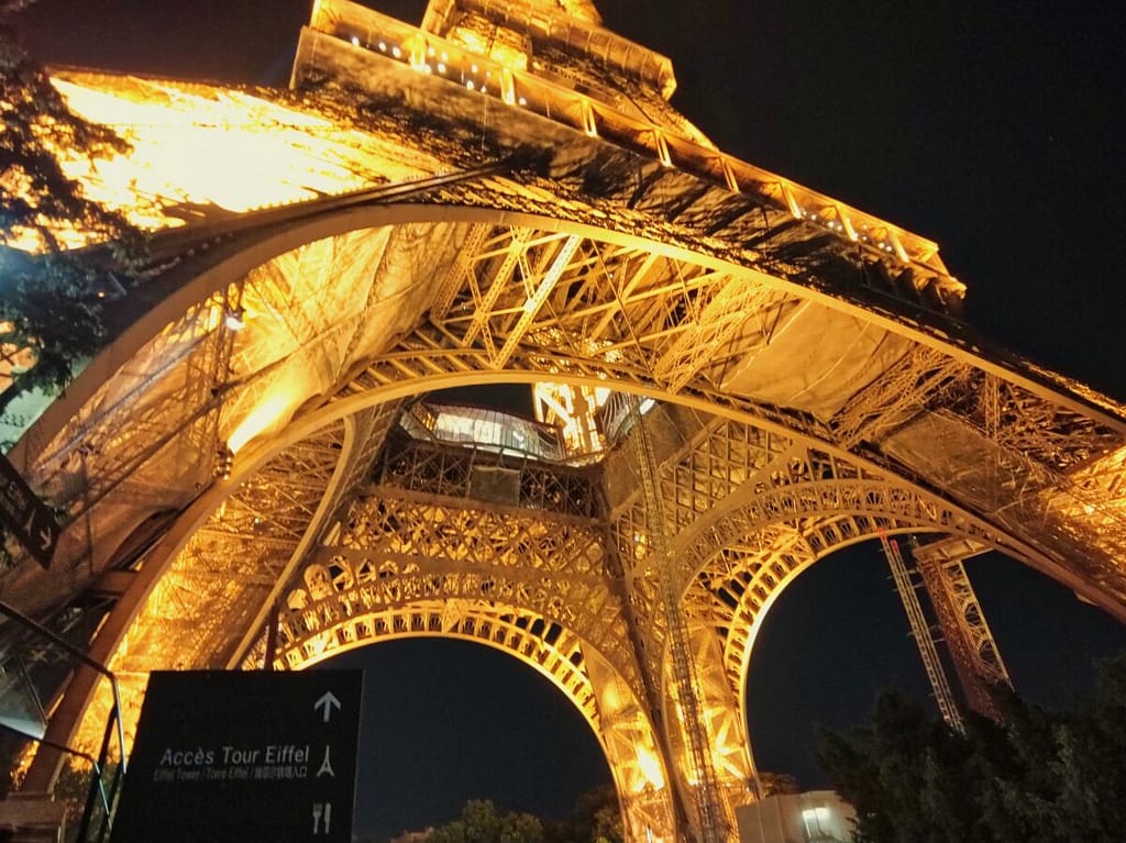 The eiffel tower is lit up at night.